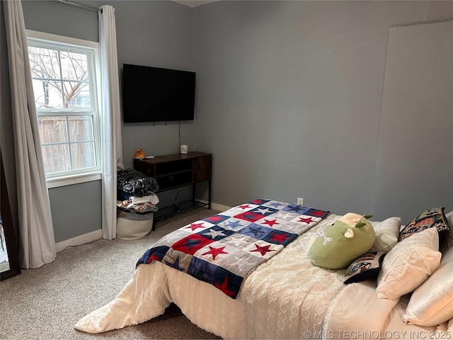 carpeted bedroom with baseboards