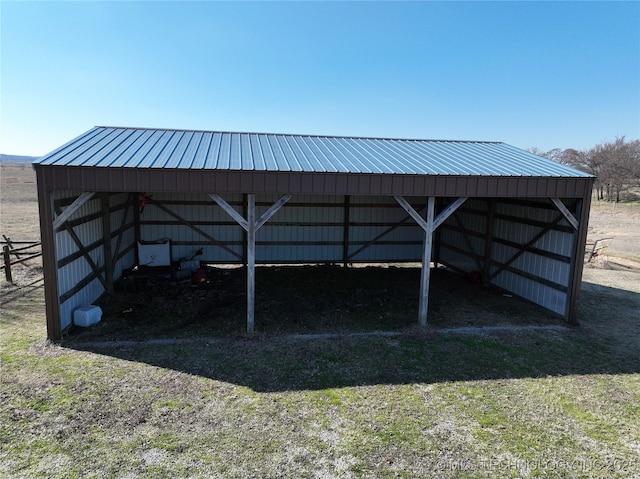view of pole building with a detached carport and a yard