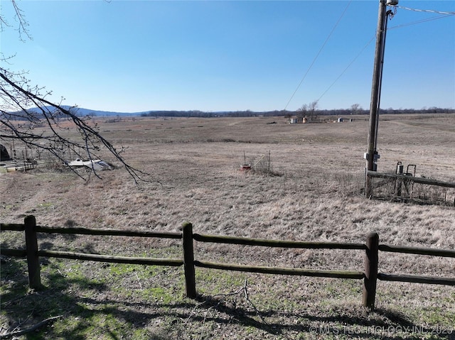 view of yard featuring a rural view and fence