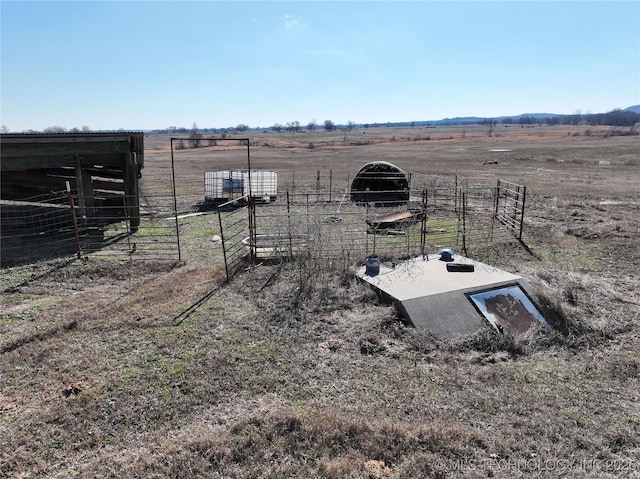 exterior space featuring an outbuilding, a rural view, and an exterior structure