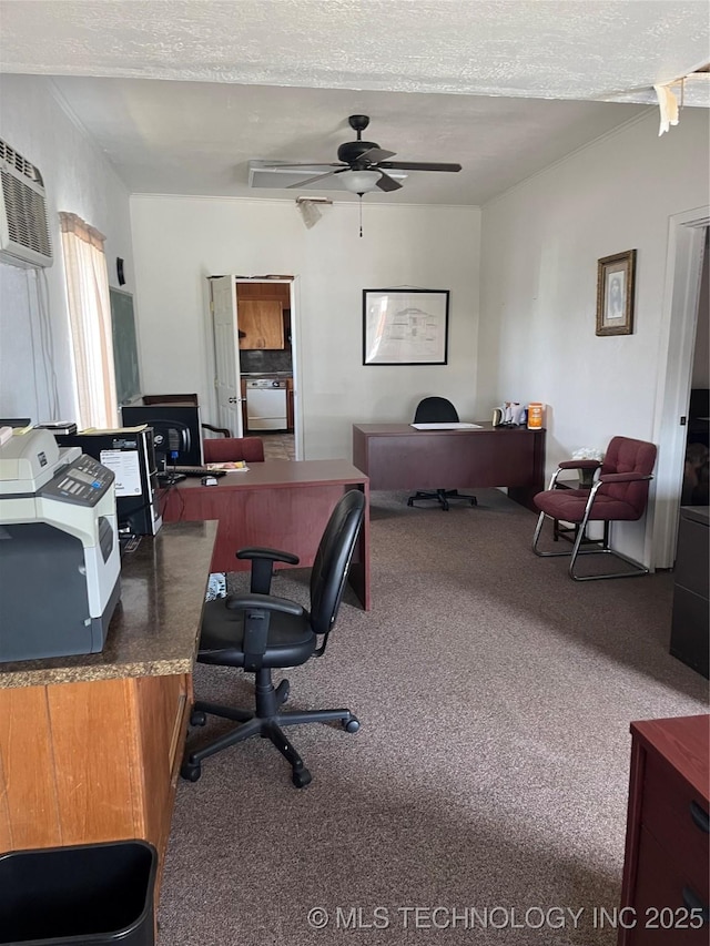 office space with a wall unit AC, a textured ceiling, ceiling fan, and carpet floors