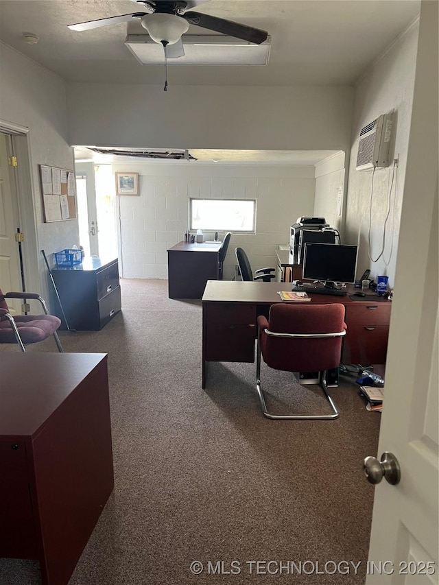 office area with an AC wall unit, concrete block wall, and ceiling fan