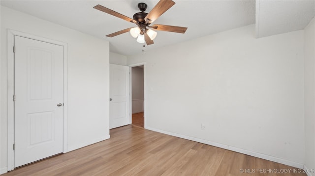 313 S Fairfax Ave, Skiatook, OK 74070 - unfurnished bedroom featuring light wood-style flooring, baseboards, and ceiling fan