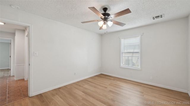 313 S Fairfax Ave, Skiatook, OK 74070 - spare room featuring baseboards, ceiling fan, visible vents, and light wood-type flooring