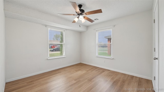 313 S Fairfax Ave, Skiatook, OK 74070 - unfurnished room featuring light wood-style flooring, baseboards, and a wealth of natural light