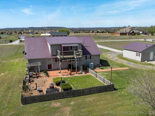 9097 N 50th W St, Sperry, OK 74073 - back of property featuring fence, a wooden deck, central air condition unit, a yard, and metal roof