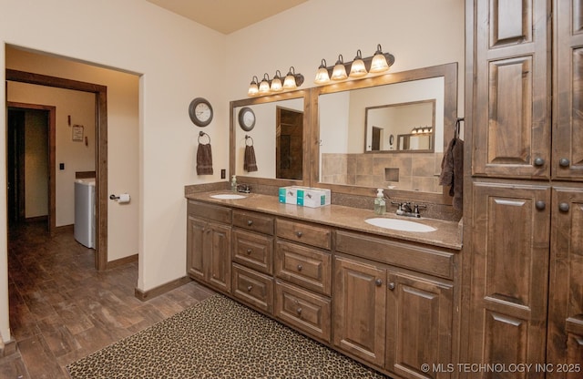 358653 E 5700th Rd, Jennings, OK 74038 - bathroom featuring wood finished floors, a sink, double vanity, and washer / clothes dryer