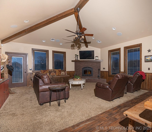 358653 E 5700th Rd, Jennings, OK 74038 - living room featuring lofted ceiling with beams, wainscoting, visible vents, wood finished floors, and a fireplace