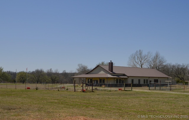 358653 E 5700th Rd, Jennings, OK 74038 - rear view of house featuring a lawn, fence, and a chimney
