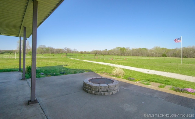 view of patio / terrace featuring a fire pit and a rural view