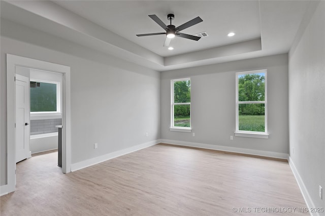 3995 Folsom Rd, Durant, OK 74701 - empty room with light wood-style floors, a raised ceiling, a ceiling fan, recessed lighting, and baseboards