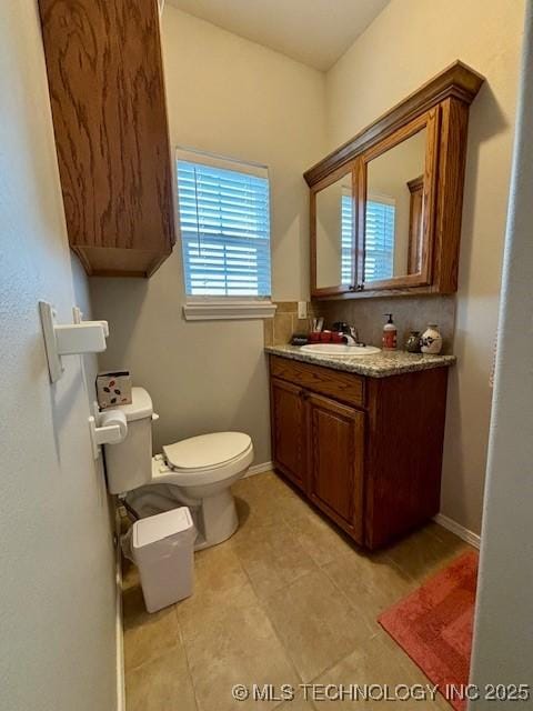 142 Elm St, Mannford, OK 74044 - bathroom featuring toilet, vanity, and tile patterned flooring