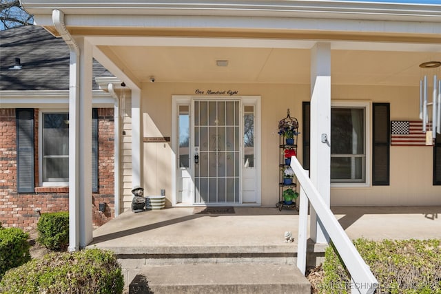 108 S Bettes Ave, Wagoner, OK 74467 - doorway to property featuring covered porch and brick siding