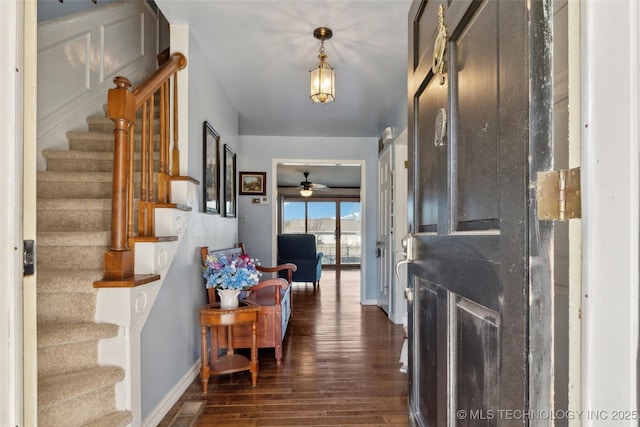 108 S Bettes Ave, Wagoner, OK 74467 - foyer entrance featuring stairway, baseboards, dark wood-style floors, visible vents, and a ceiling fan