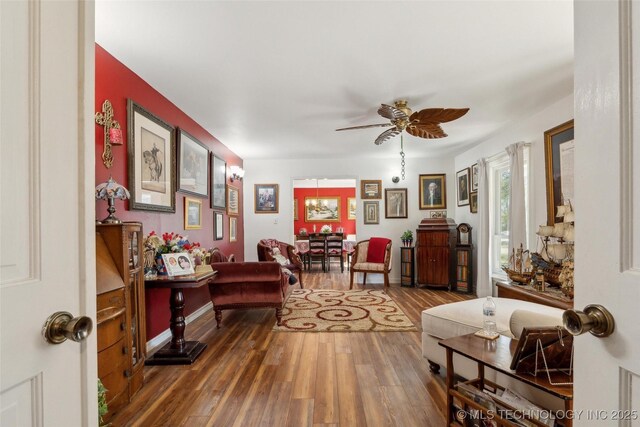 108 S Bettes Ave, Wagoner, OK 74467 - living area featuring baseboards, wood finished floors, and ceiling fan