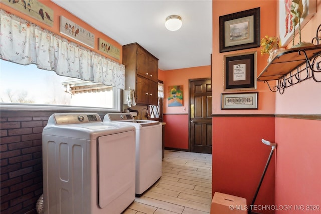 108 S Bettes Ave, Wagoner, OK 74467 - clothes washing area with washing machine and clothes dryer, cabinet space, and light wood-type flooring