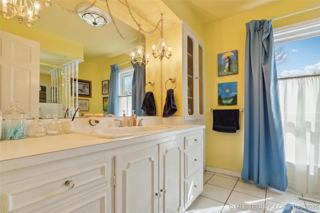 108 S Bettes Ave, Wagoner, OK 74467 - bathroom featuring a notable chandelier, tile patterned floors, and vanity