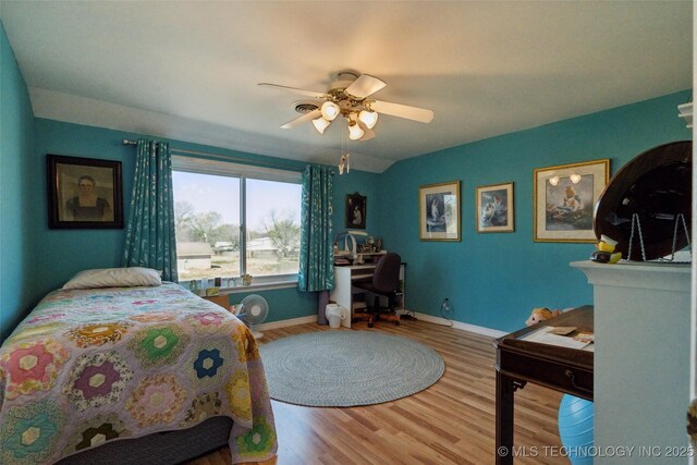 108 S Bettes Ave, Wagoner, OK 74467 - bedroom featuring baseboards, wood finished floors, and ceiling fan