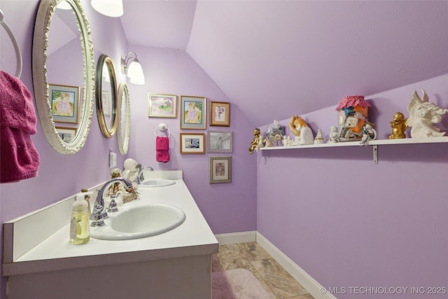 108 S Bettes Ave, Wagoner, OK 74467 - bathroom with double vanity, a sink, baseboards, and lofted ceiling