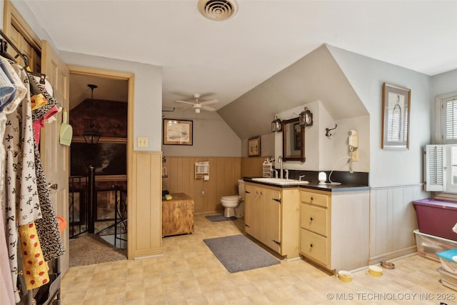 108 S Bettes Ave, Wagoner, OK 74467 - bathroom with toilet, vanity, a ceiling fan, wainscoting, and visible vents