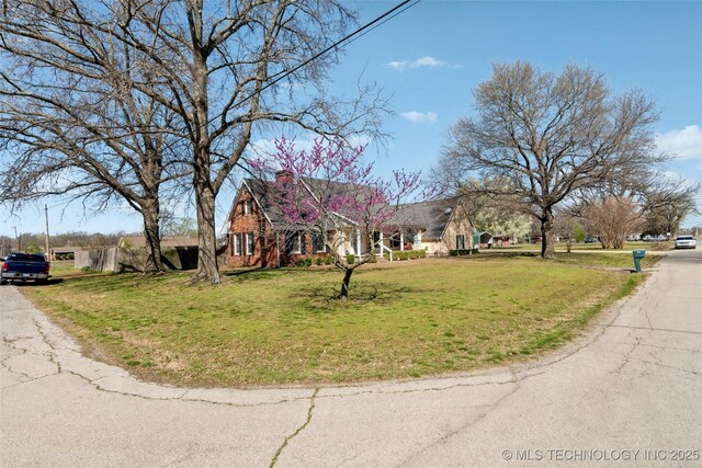 108 S Bettes Ave, Wagoner, OK 74467 - view of front of property with a front yard and a chimney