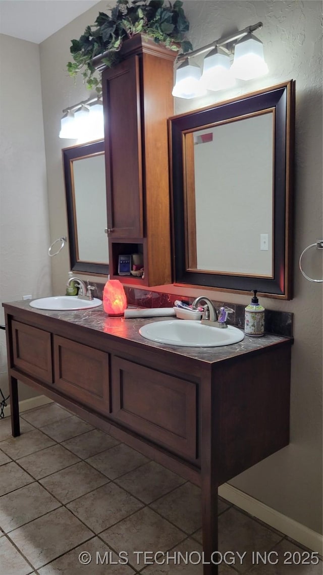6111 County Road 3605, Ada, OK 74820 - bathroom featuring baseboards, double vanity, and a sink