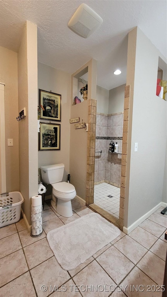 6111 County Road 3605, Ada, OK 74820 - full bath with tile patterned flooring, toilet, baseboards, and a walk in shower