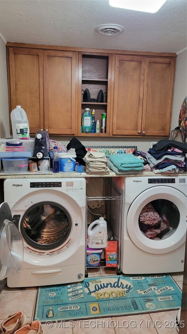 6111 County Road 3605, Ada, OK 74820 - laundry area featuring a textured ceiling, cabinet space, washer / clothes dryer, and visible vents
