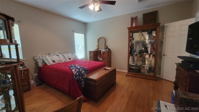 6111 County Road 3605, Ada, OK 74820 - bedroom with visible vents, baseboards, ceiling fan, and wood finished floors