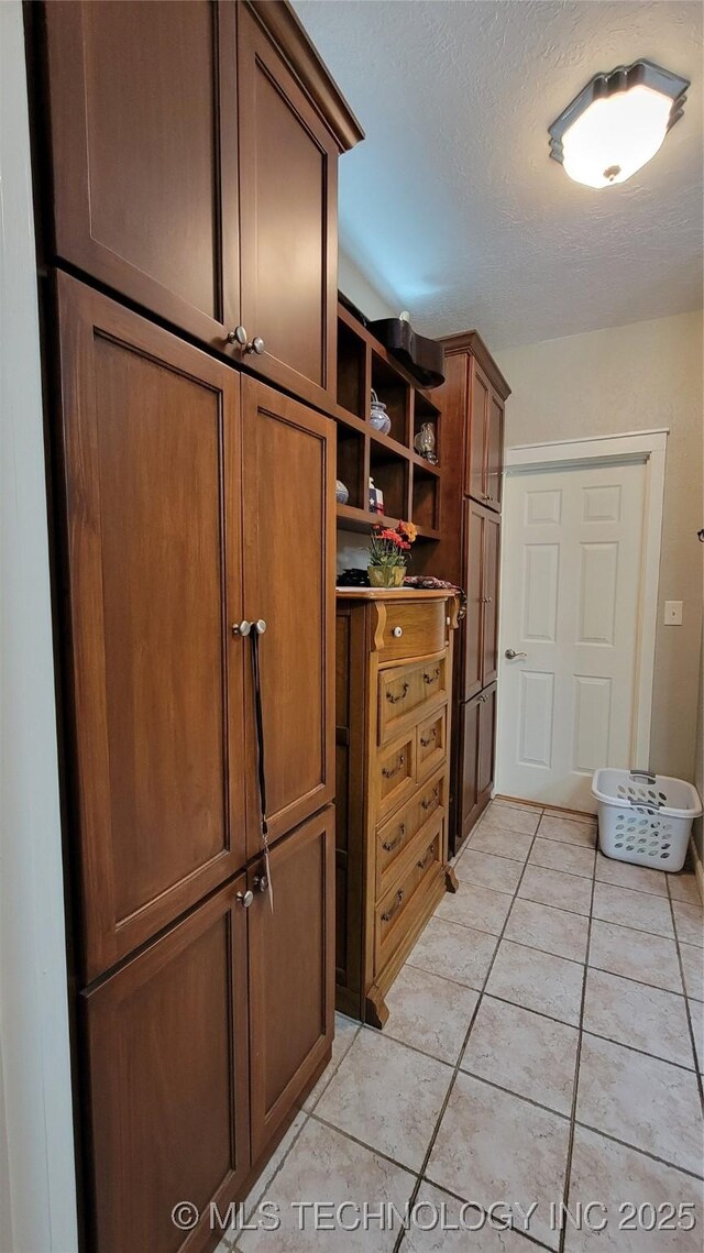 6111 County Road 3605, Ada, OK 74820 - interior space with a textured ceiling and light tile patterned floors