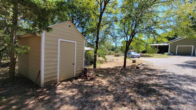 6111 County Road 3605, Ada, OK 74820 - view of shed with gravel driveway and an attached garage