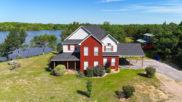 76 Cris, Durant, OK 74701 - traditional-style home with driveway, a front lawn, a carport, a water view, and covered porch