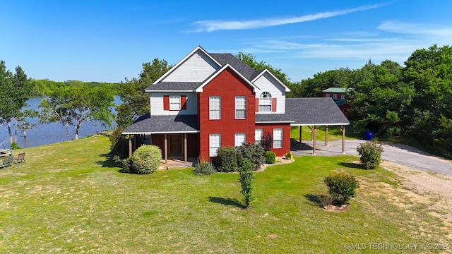 76 Cris, Durant, OK 74701 - view of front of home with driveway, a shingled roof, a front yard, a water view, and a carport