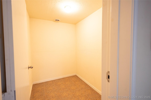 2 Aspen, Davis, OK 73030 - unfurnished room featuring baseboards and a textured ceiling