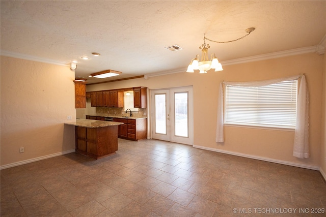 2 Aspen, Davis, OK 73030 - kitchen featuring a sink, a peninsula, brown cabinetry, visible vents, and ornamental molding