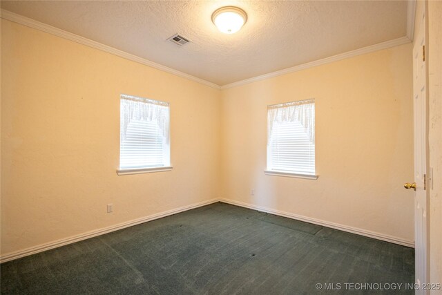 2 Aspen, Davis, OK 73030 - empty room featuring ornamental molding, visible vents, plenty of natural light, and dark colored carpet