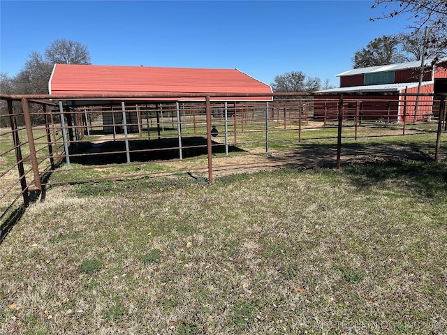 view of yard with an outdoor structure, an exterior structure, and a rural view
