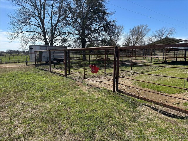 view of yard with an outdoor structure and a rural view
