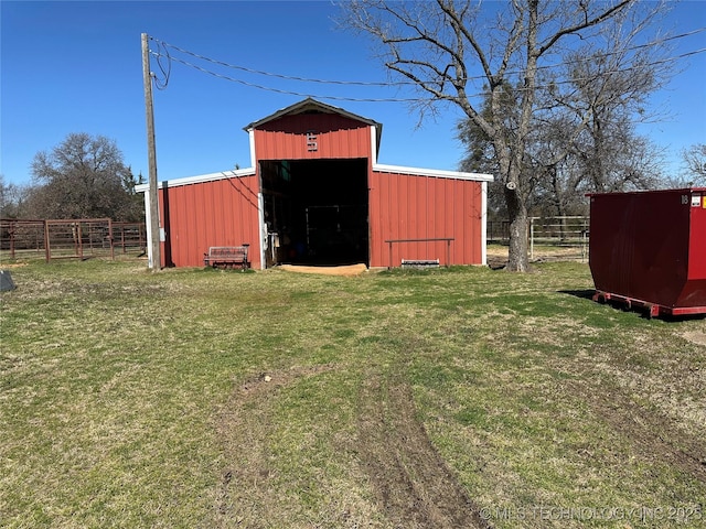 view of pole building featuring a yard and fence