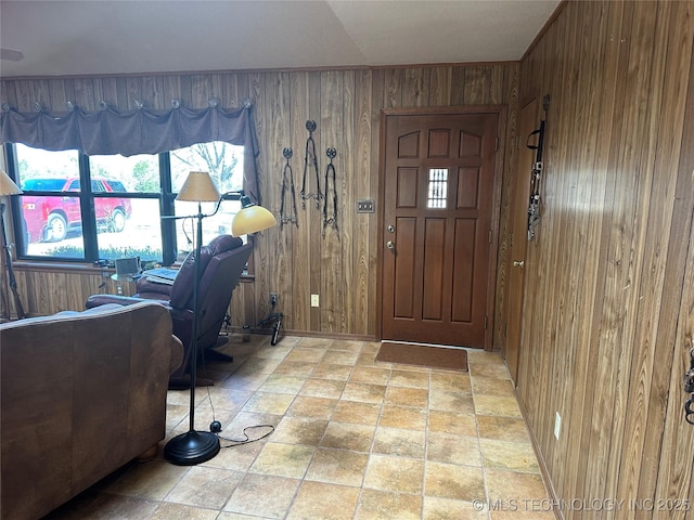 foyer entrance featuring wooden walls