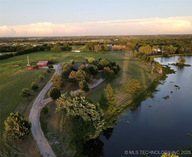 aerial view at dusk with a water view and a rural view