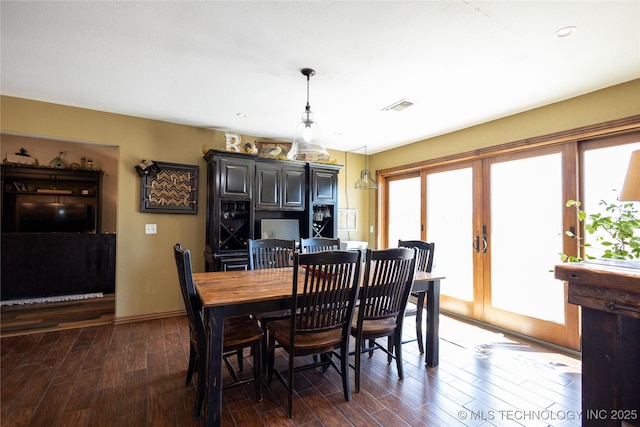dining area with french doors, dark wood-style flooring, and visible vents