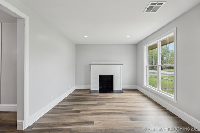 719 S 7th St, Muskogee, OK 74401 - unfurnished living room featuring a fireplace, recessed lighting, and wood finished floors