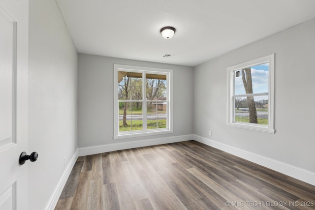 719 S 7th St, Muskogee, OK 74401 - unfurnished room with baseboards and dark wood-style floors