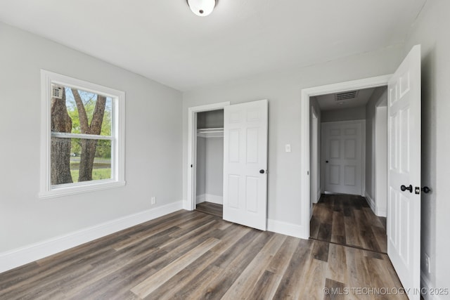719 S 7th St, Muskogee, OK 74401 - unfurnished bedroom with wood finished floors and a closet