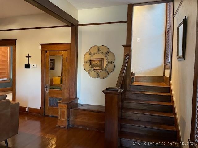 stairway featuring wood finished floors