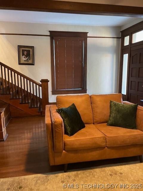 living area with wood finished floors and stairway