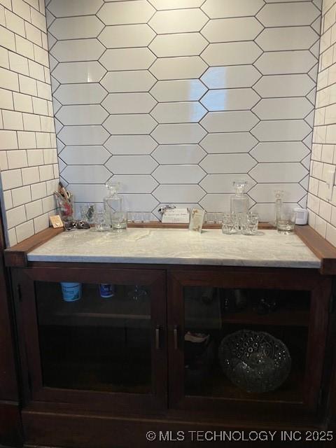 dining area with tile walls and a dry bar