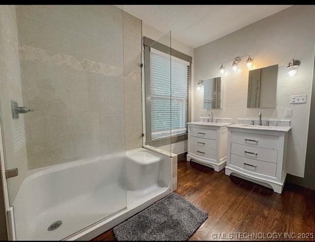 full bathroom featuring wood finished floors, vanity, a shower, and a bathtub