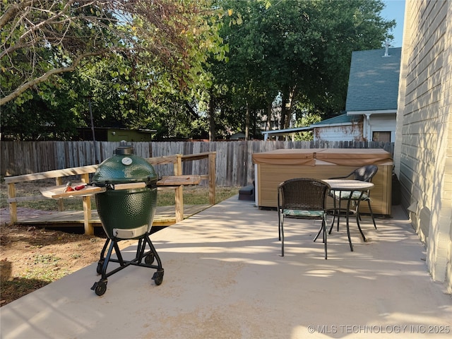 121 F SW, Ardmore, OK 73401 - fenced backyard with a patio, a hot tub, and area for grilling